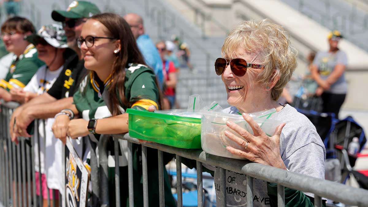 Manitowoc resident Nancy Beaulieu, known as The Cookie Lady in the Green Bay Packers community, offers fresh baked goods to players after training camp on Aug. 1, 2025, outside Lambeau Field in Green Bay, Wis.