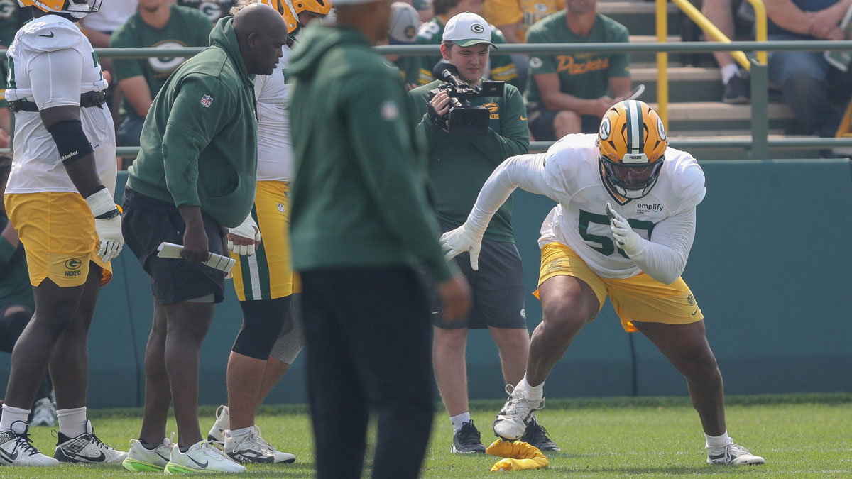 Green Bay Packers offensive tackle Zach Tom (50) runs through a drill during practice on Thursday, July 31, 2025, at Ray Nitschke Field in Ashwaubenon, Wis.