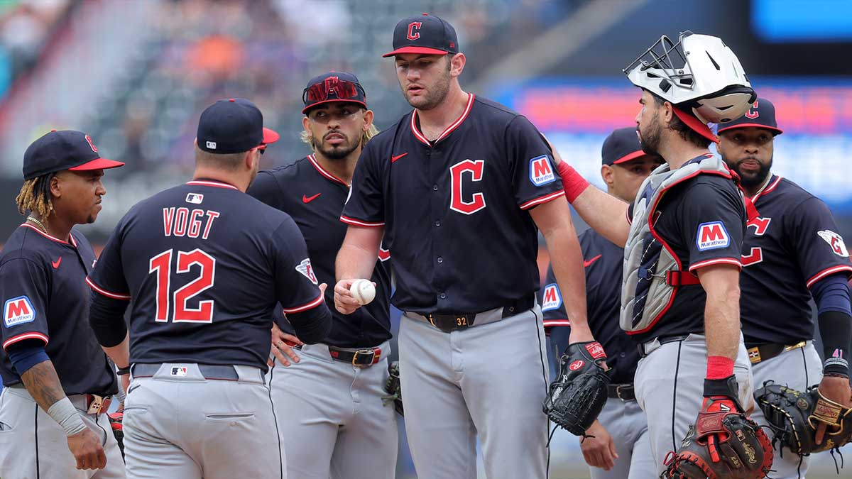 Cleveland Guardians manager Stephen Vogt (12) takes the ball from starting pitcher Gavin Williams (32) during a pitching change during the ninth inning against the New York Mets at Citi Field.