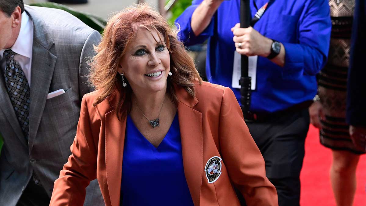 basketball player and broadcaster Nancy Lieberman arrives at Symphony Hall for the 2023 Basketball Hall of Fame induction with Caitlin Clark and Jeff Teague in the background