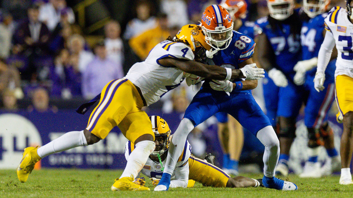 LSU Tigers linebacker Harold Perkins Jr. (4) tackles Florida Gators wide receiver Marcus Burke (88) during the second half at Tiger Stadium.