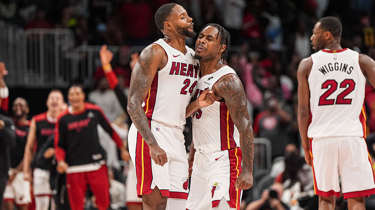 Miami Heat guard Davion Mitchell (45) reacts with forward Haywood Highsmith (24) after the Heat defeated the Atlanta Hawks in overtime at State Farm Arena.