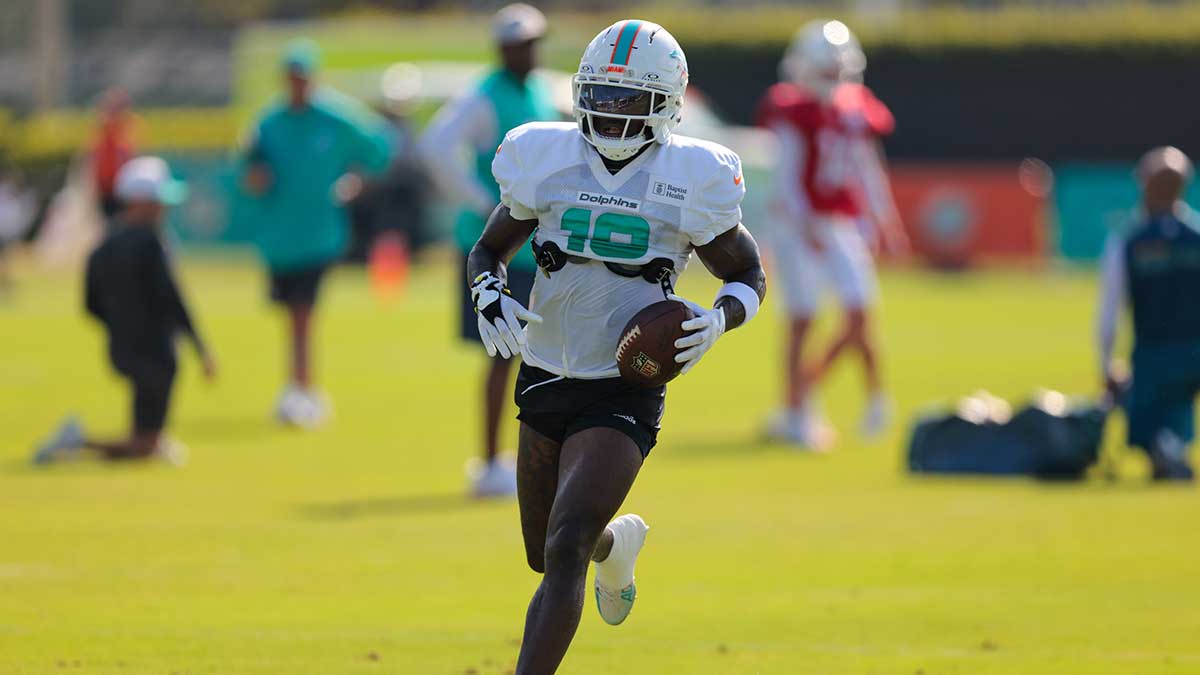 Miami Dolphins wide receiver Tyreek Hill (10) runs with the football during training camp at Baptist Health Training Complex.
