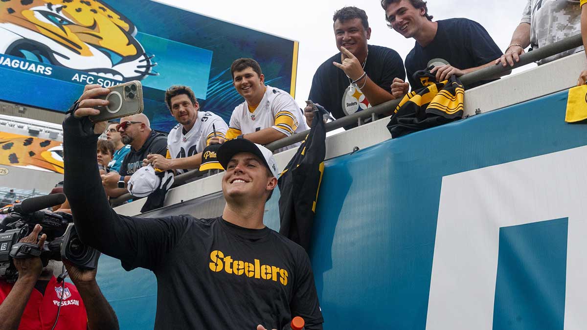 Pittsburgh Steelers quarterback Will Howard (18) takes a selfie with a fan before the game against the Jacksonville Jaguars at EverBank Stadium.