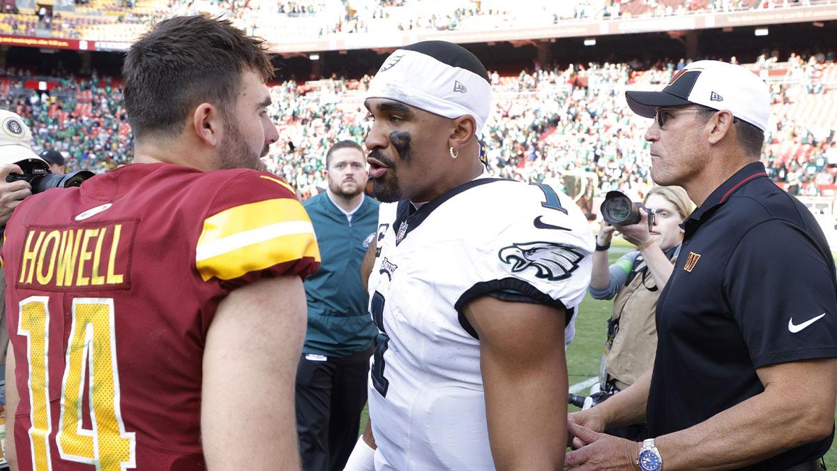 Washington Commanders quarterback Sam Howell (14) talks with Philadelphia Eagles quarterback Jalen Hurts (1) after their game at FedExField.