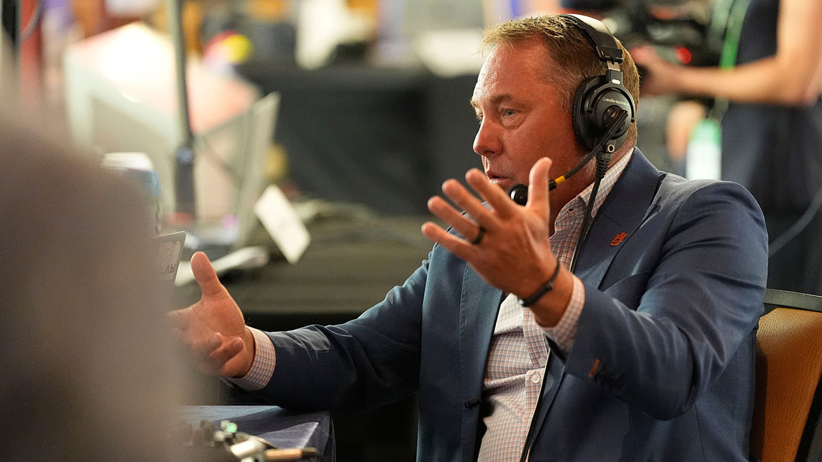 Auburn head coach Hugh Freeze talks to a radio personality during SEC Media Days at the College Football Hall of Fame in Atlanta.