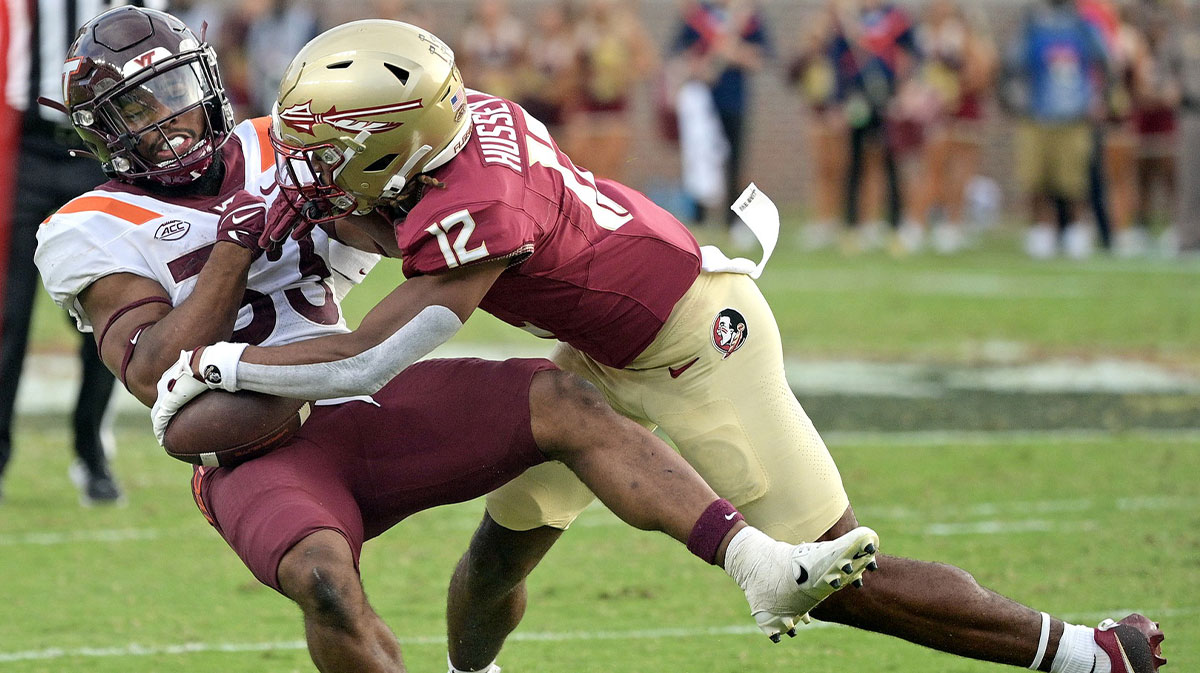 Florida State Seminoles defensive back Conrad Hussey (12) tackles Virginia Tech Hokies running back Bhayshul Tuten (33) during the second half against the at Doak S. Campbell Stadium.
