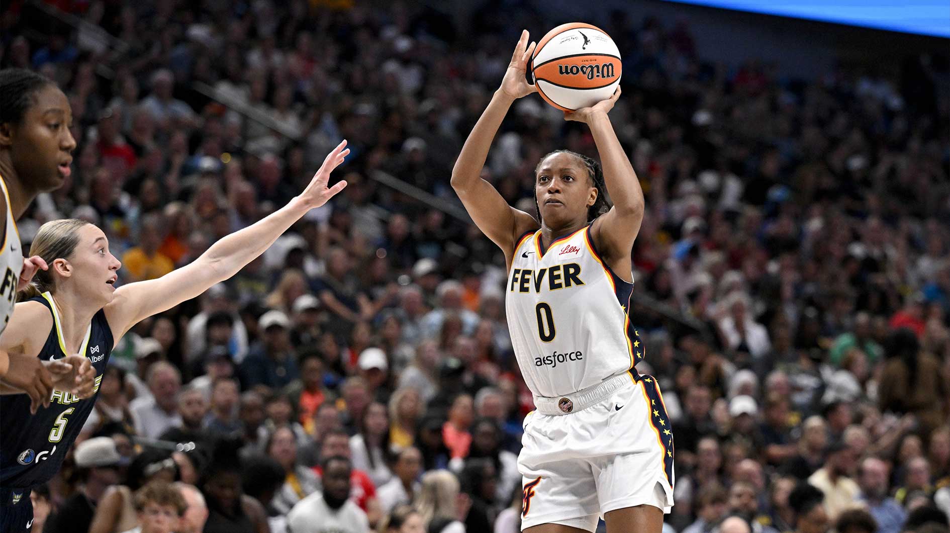 Indiana Fever guard Kelsey Mitchell (0) makes a jump shot over Dallas Wings guard Paige Bueckers (5) during the second half at the American Airlines Center.