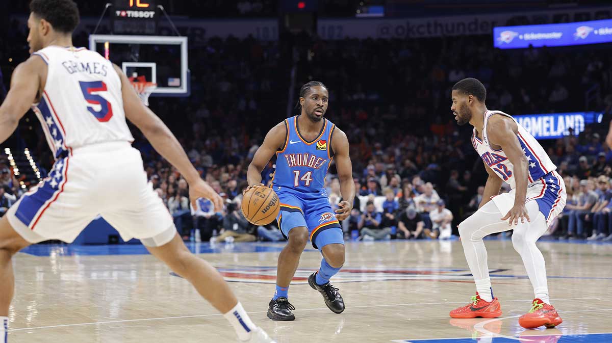 Oklahoma City Thunder forward Adam Flagler (14) dribbles down the court beside Philadelphia 76ers guard Jared Butler (12) during the second half at Paycom Center.