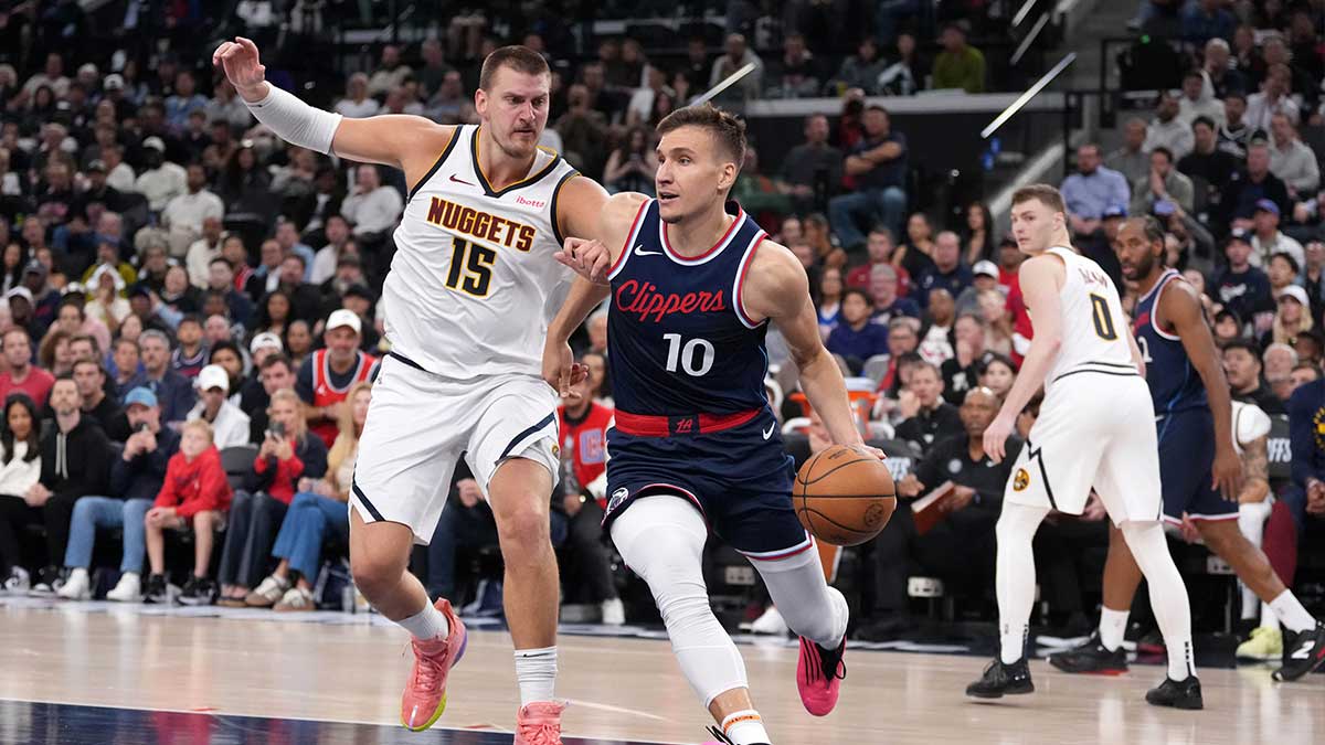 LA Clippers guard Bogdan Bogdanovic (10) dribbles the ball against Denver Nuggets center Nikola Jokic (15) in the second half during game six of first round for the 2025 NBA Playoffs at Intuit Dome.