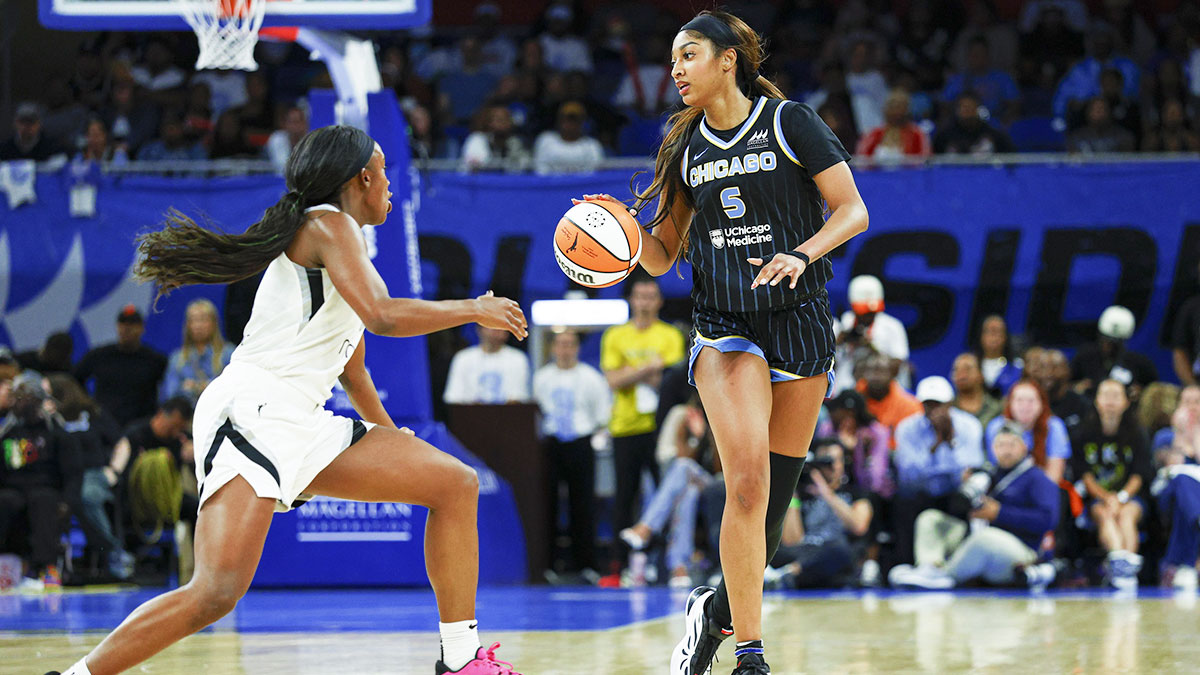 Chicago Sky forward Angel Reese (5) brings the ball up court against Las Vegas Aces guard Jackie Young (0) during the first half at Wintrust Arena.