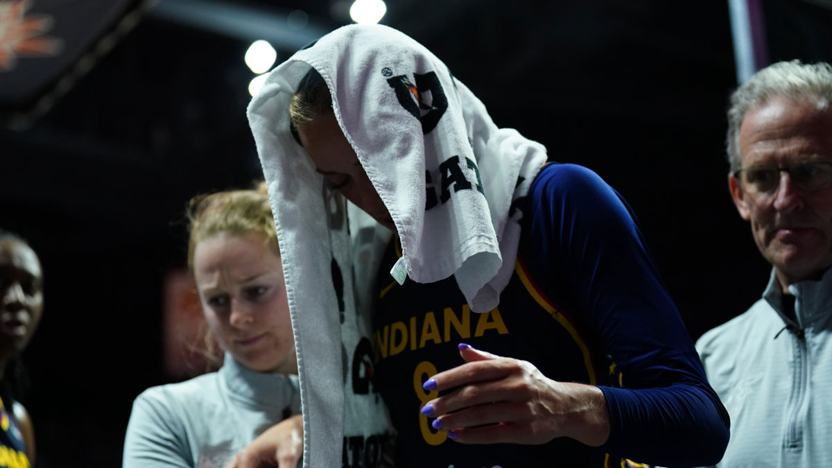 Aug 17, 2025; Uncasville, Connecticut, USA; Indiana Fever guard Sophie Cunningham (8) is helped off the court injured as they take on the Connecticut Sun in the first half at Mohegan Sun Arena. Mandatory Credit: David Butler II-Imagn Images