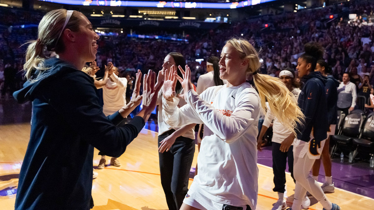Indiana Fever guard Sophie Cunningham (right) greets teammate Lexie Hull against the Phoenix Mercury during an WNBA game.