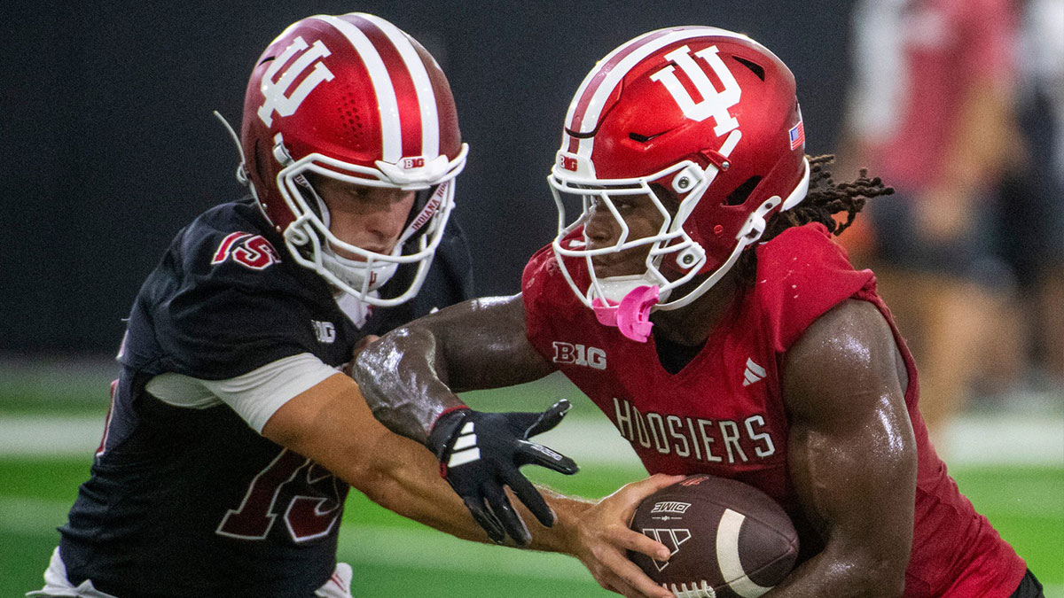 Indiana's Roman Hemby (1) takes the handoff from Fernando Mendoza (15) at Indiana University football practice on Thursday, July 31, 2025.