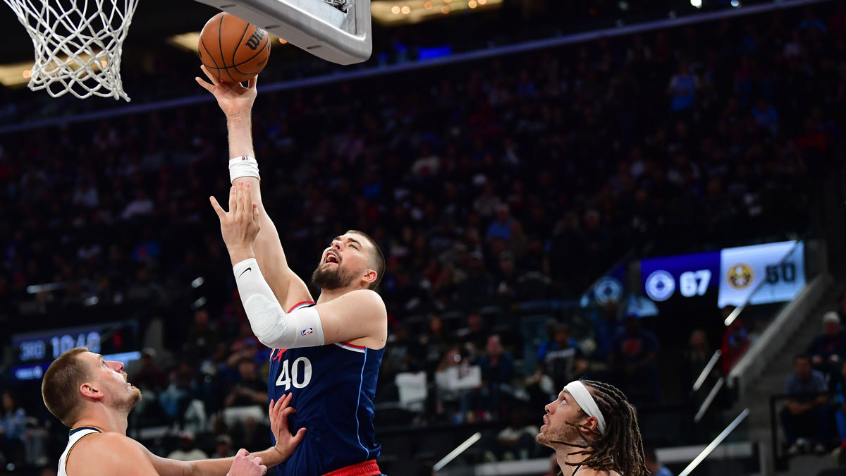 Los Angeles Clippers center Ivica Zubac (40) shoots against Denver Nuggets center Nikola Jokic (15) and forward Aaron Gordon (32) during the second half of game three in the first round for the 2024 NBA Playoffs at Intuit Dome.