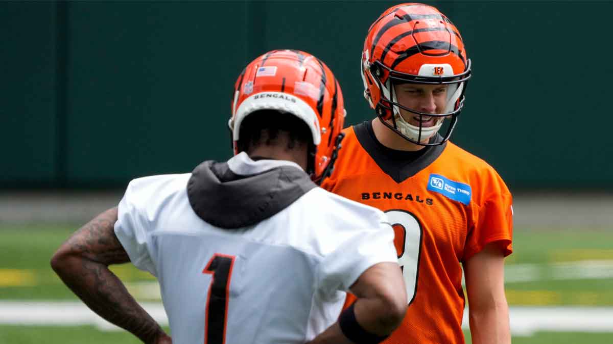 Cincinnati Bengals quarterback Joe Burrow (9) talks with wide receiver Ja'Marr Chase (1) during an off-season workout inside Paycor Stadium in downtown Cincinnati.