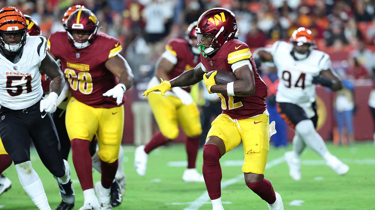 Aug 18, 2025; Landover, Maryland, USA; Washington Commanders running back Jacory Croskey-Merritt (32) carries the ball against the Cincinnati Bengals during the second half