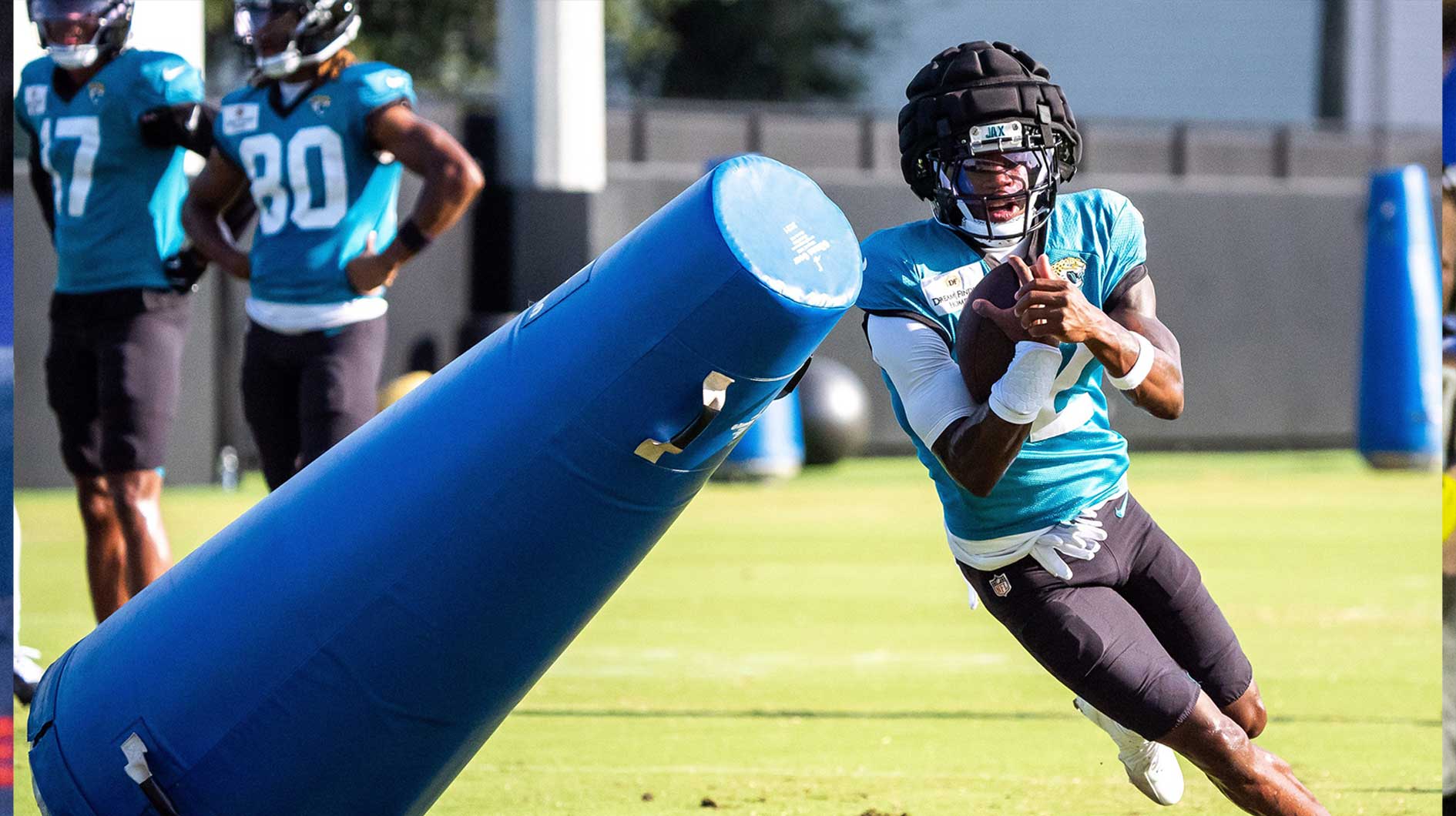 Jacksonville Jaguars wide receiver Travis Hunter (12) rounds a tackling dummy after hauling in a pass during an NFL training camp session ten at the Miller Electric Center, Tuesday, Aug. 5, 2025, in Jacksonville, Fla.