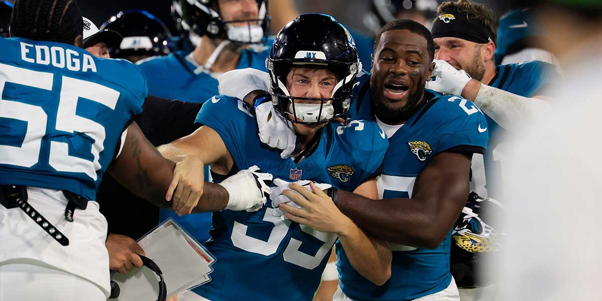 Jacksonville Jaguars place kicker Cam Little (39) is celebrated for his 70-yard field goal by cornerback Jarrian Jones (22) and others during the second quarter of an NFL preseason matchup at EverBank Stadium,
