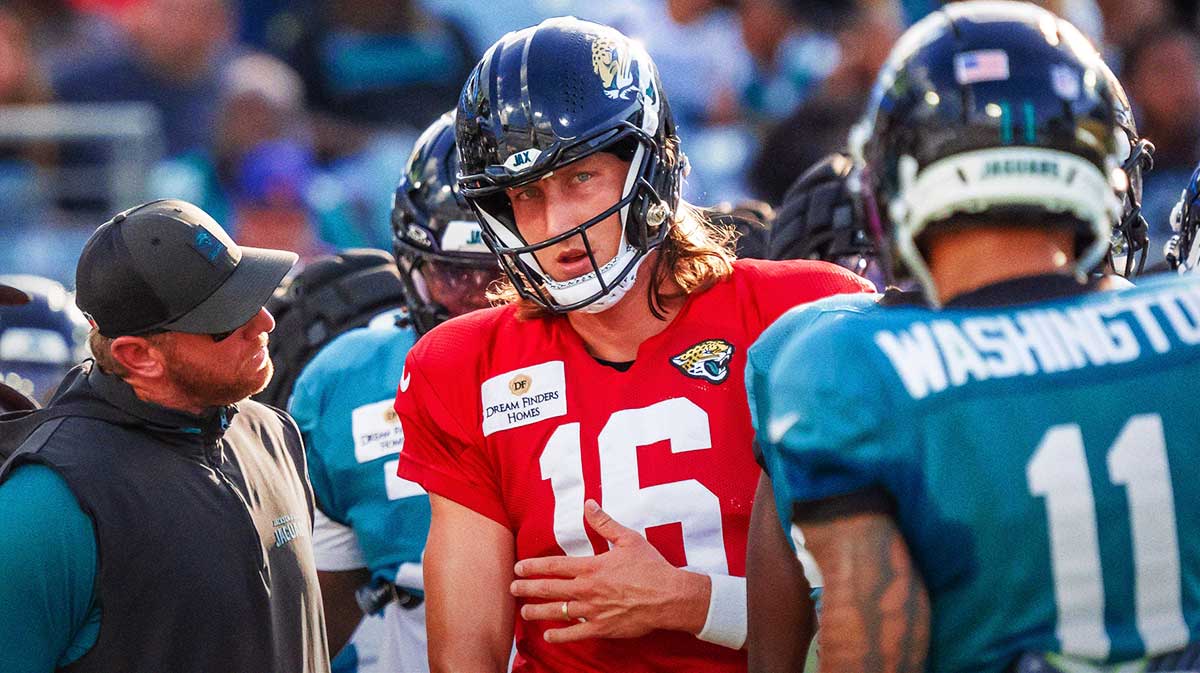 Jaguars head coach Liam Coen talks with Jacksonville Jaguars quarterback Trevor Lawrence (16) between plays before an NFL scrimmage at EverBank Stadium