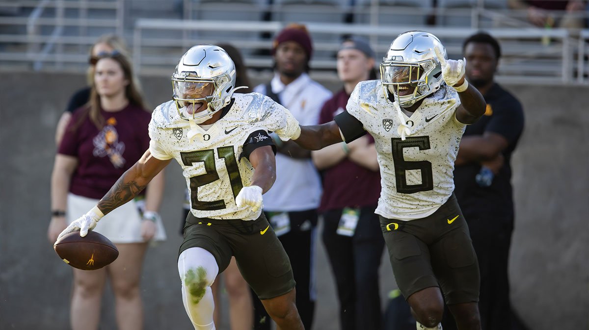 Oregon Ducks defensive back Cole Martin (21) celebrates an interception with teammate Jahlil Florence (6) against the Arizona State Sun Devils in the second half at Mountain America Stadium.