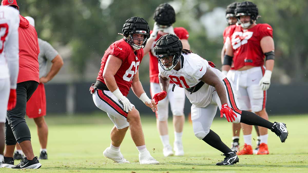 Tampa Bay Buccaneers center Jake Majors (65) and defensive end Mike Greene (91) participate in training camp at AdventHealth Training Center.