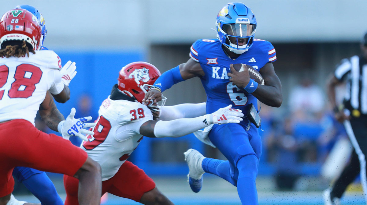 Kansas Jayhawks quarterback Jalon Daniels (6) runs for yards during the game between Fresno State and Kansas at David Booth Kansas Memorial Stadium.