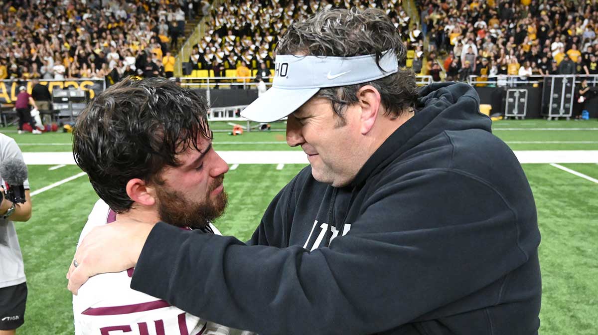Idaho Vandals head coach Jason Eck, right, talks with Southern Illinois Salukis quarterback Nic Baker (8) after a game at Kibble Dome. Idaho won 20-17 in OT.