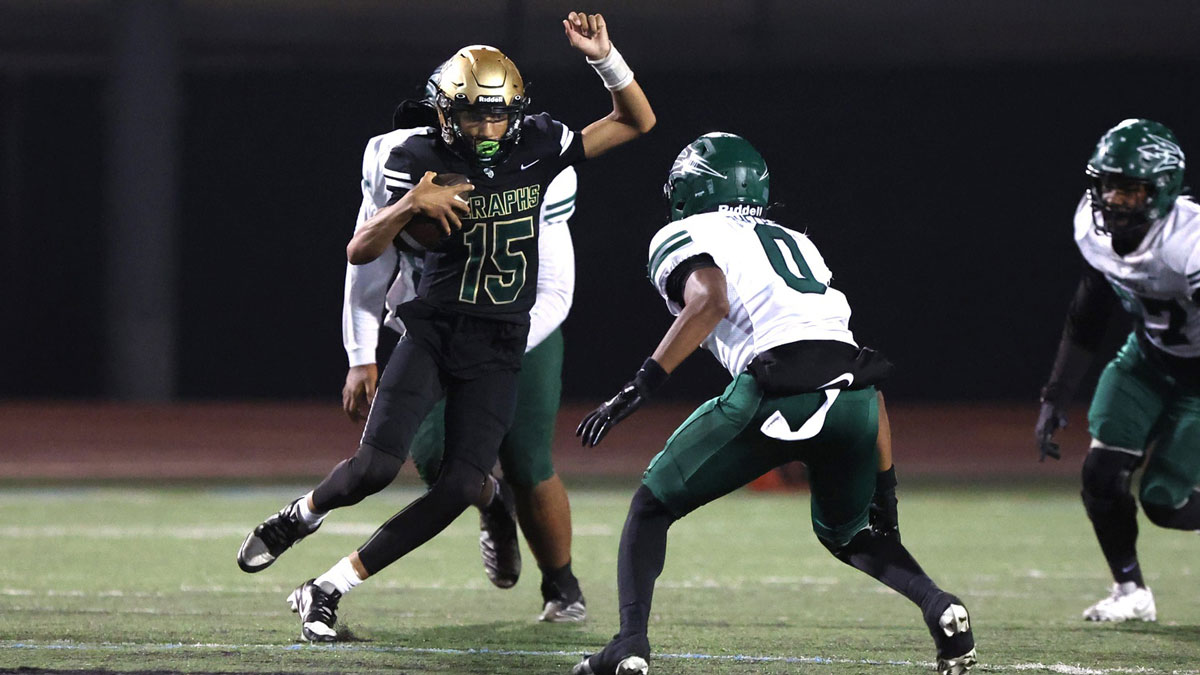 St. Bonaventure's quarterback Jaxson Carper tries to avoid Pacifica's Isaiah Phelps during the second quarter of the Marmonte League football game Friday night at Buena High School. St. Bonaventure won, 37-35.