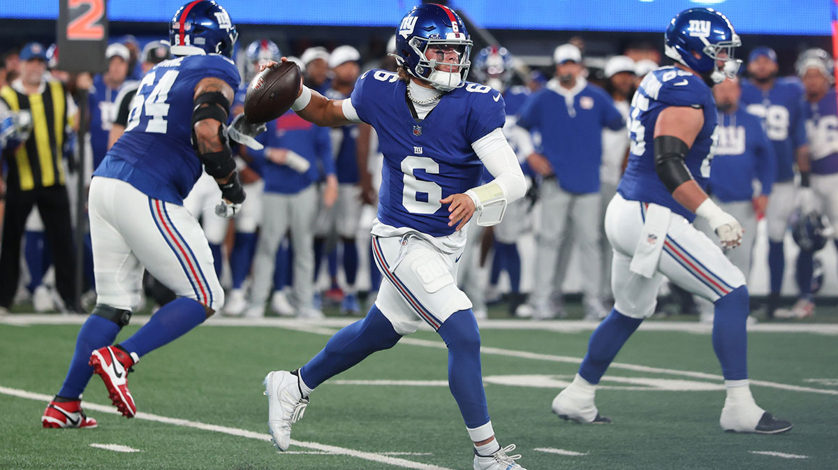 New York Giants quarterback Jaxson Dart, whose necklace is a good luck charm, throwing a pass against the New England Patriots in their preseason game.