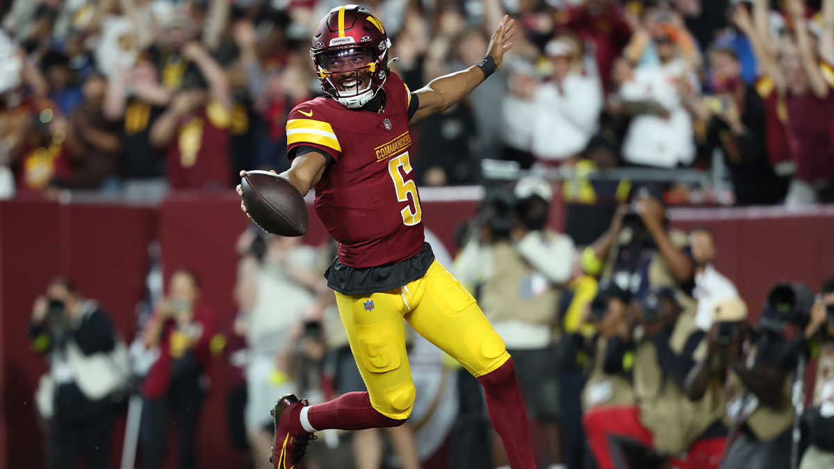 Washington Commanders quarterback Jayden Daniels (5) celebrates after scoring a touchdown against Cincinnati Bengals during the first half at Northwest Stadium.
