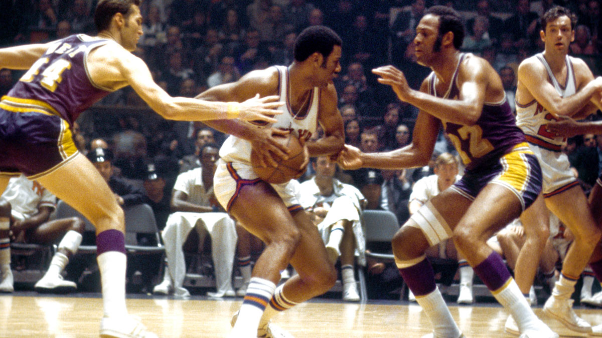 New York Knicks forward Dave Stallworth (9) is defended by Los Angeles Lakers guard Jerry West (44) and forward Elgin Baylor (22) during the 1970 NBA Finals at Madison Square Garden.