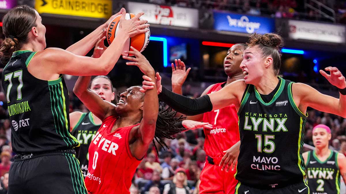 Minnesota Lynx forward Maria Kliundikova (77) and Indiana Fever guard Kelsey Mitchell (0) fight for the rebound Friday, Aug. 22, 2025, during a game between the Indiana Fever and the Minnesota Lynx at Gainbridge Fieldhouse in Indianapolis.