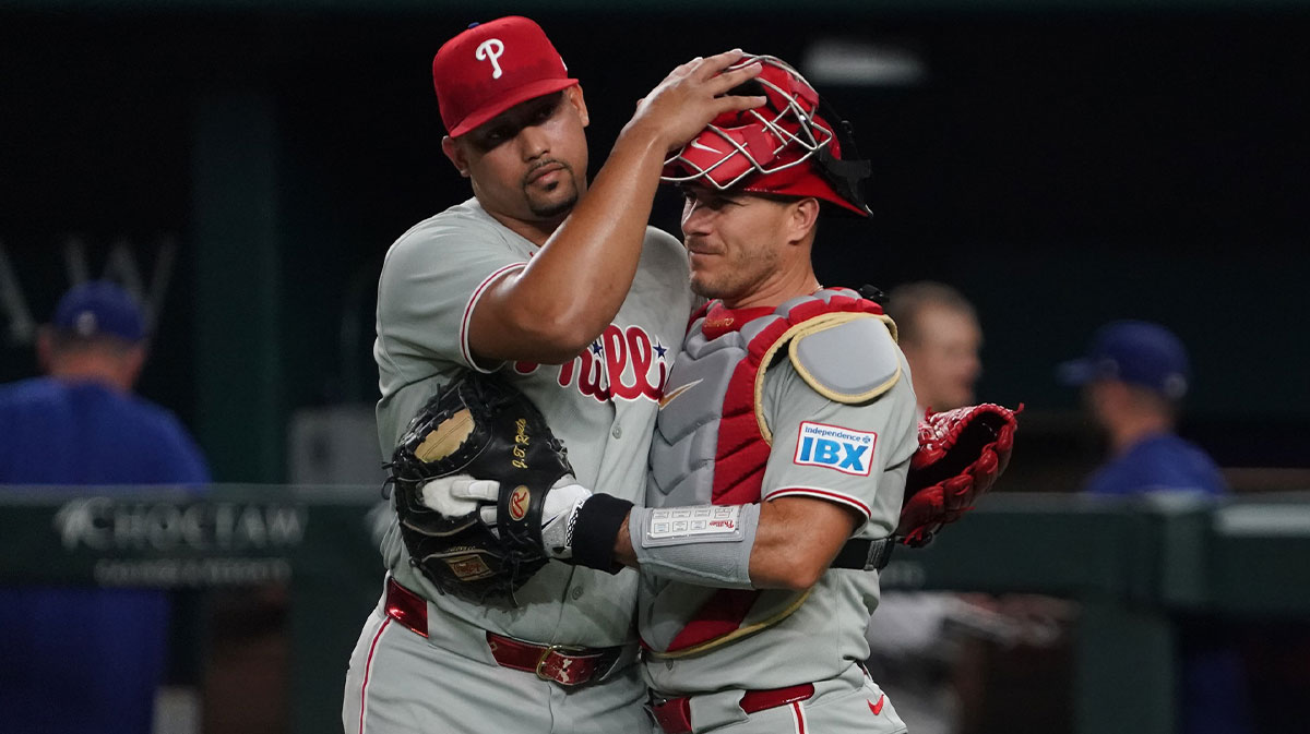Philadelphia Phillies pitcher Jhoan Duran (59) pats catcher J.T. Realmuto (10) not he head after the game against the Texas Rangers at Globe Life Field.