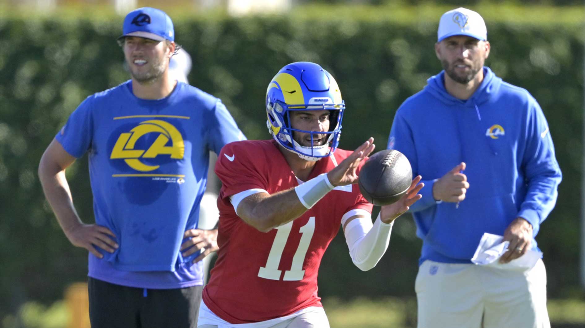 Los Angeles Rams quarterback Matthew Stafford (9) and quarterbacks coach Dave Ragone look on as quarterback Jimmy Garoppolo (11) participates in drills during training camp at Loyola Marymount University.