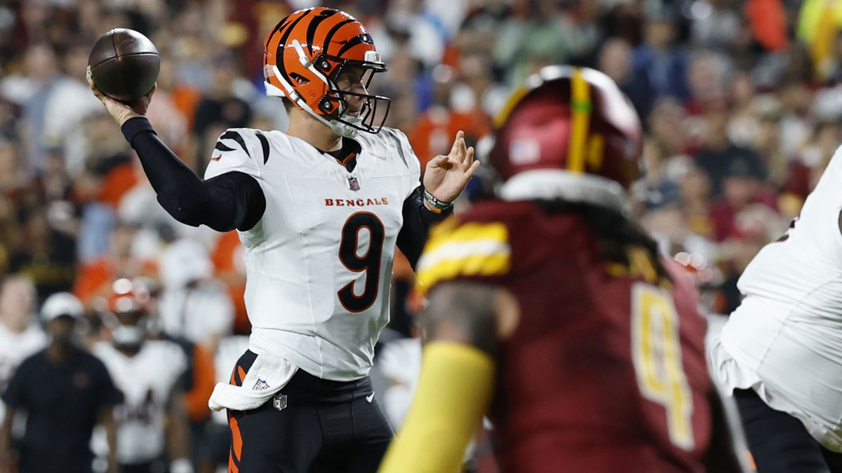 Cincinnati Bengals quarterback Joe Burrow (9) passes the ball as Washington Commanders linebacker Frankie Luvu (4) looks on during the first quarter at Northwest Stadium.