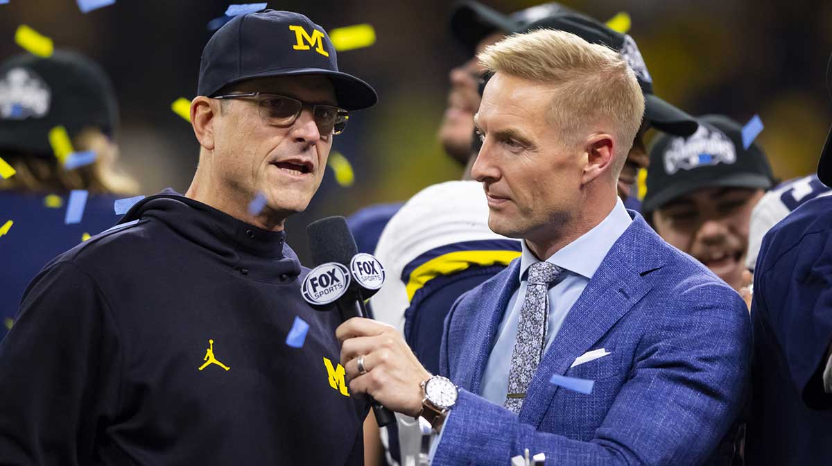 Fox Sports analyst Joel Klatt interviews Michigan Wolverines head coach Jim Harbaugh after defeating the Iowa Hawkeyes in the Big Ten Conference championship game at Lucas Oil Stadium.