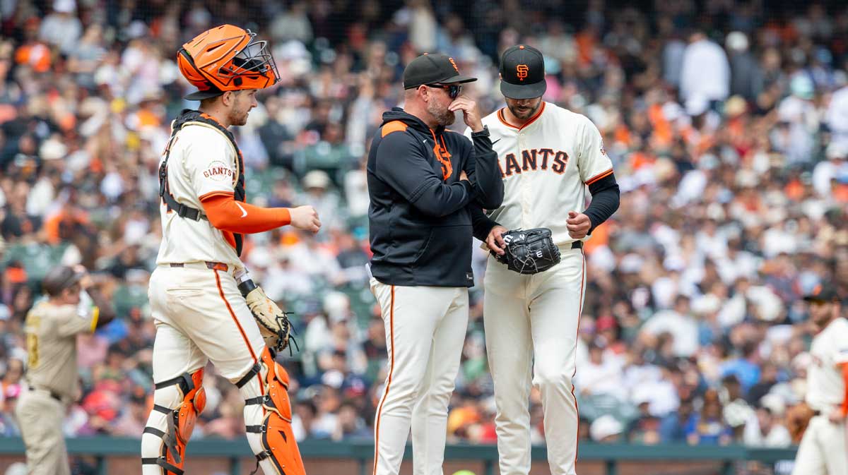 San Francisco Giants pitcher Joey Lucchesi (57) has a mound visit during the fifth inning against the San Diego Padres at Oracle Park.
