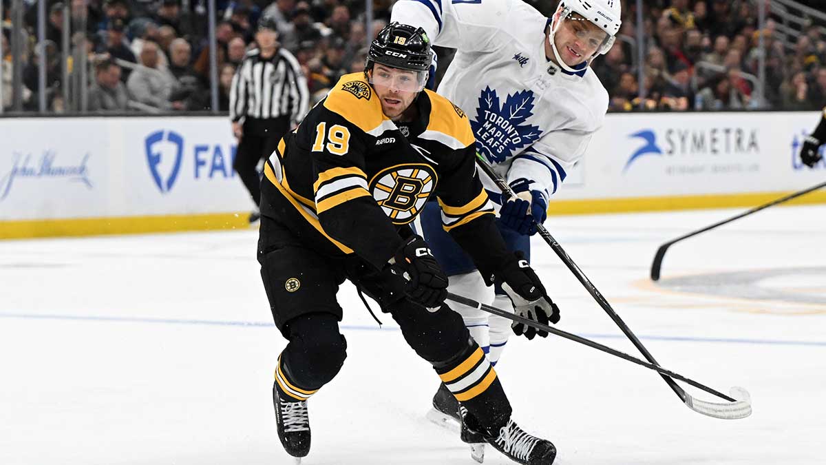 Boston Bruins center John Beecher (19) and Toronto Maple Leafs center Max Domi (11) battle for the puck during the second period at the TD Garden.