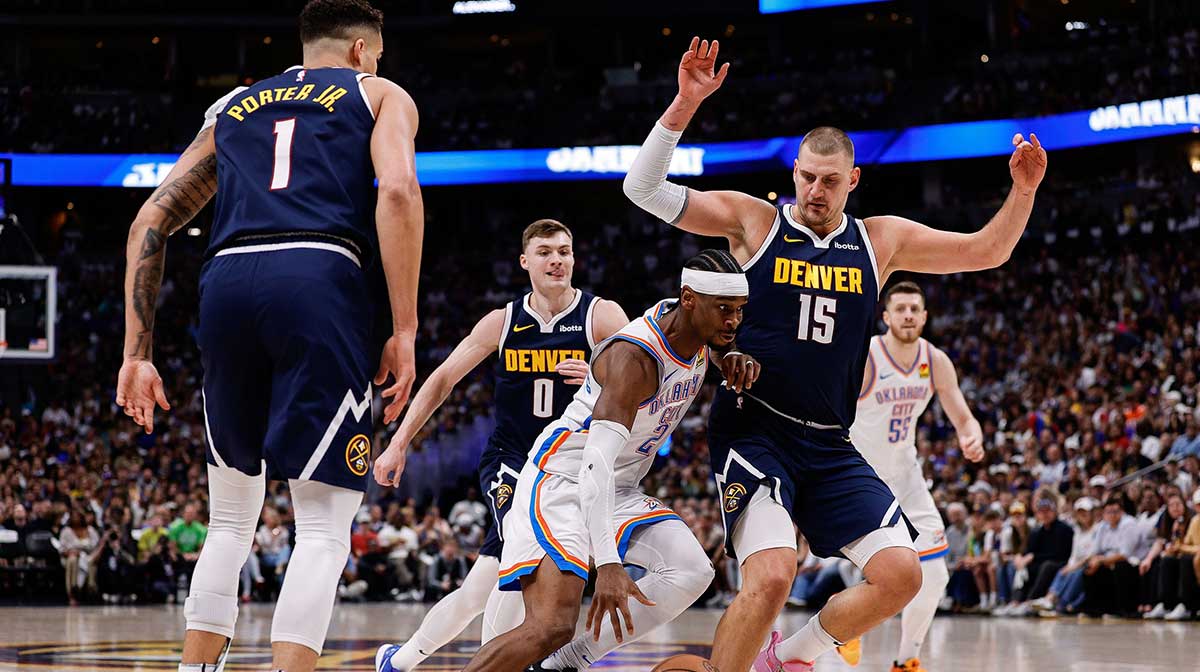 Oklahoma City Thunder guard Shai Gilgeous-Alexander (2) controls the ball against Denver Nuggets center Nikola Jokic (15) and guard Christian Braun (0) and forward Michael Porter Jr. (1) in the first quarter during game four of the second round of the 2025 NBA Playoffs at Ball Arena.