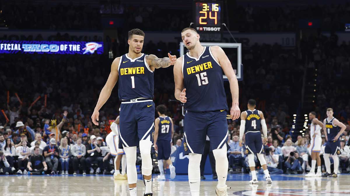 Denver Nuggets forward Michael Porter Jr. (1) and center Nikola Jokic (15) talk during a time out against the Oklahoma City Thunder during the second half at Paycom Center.