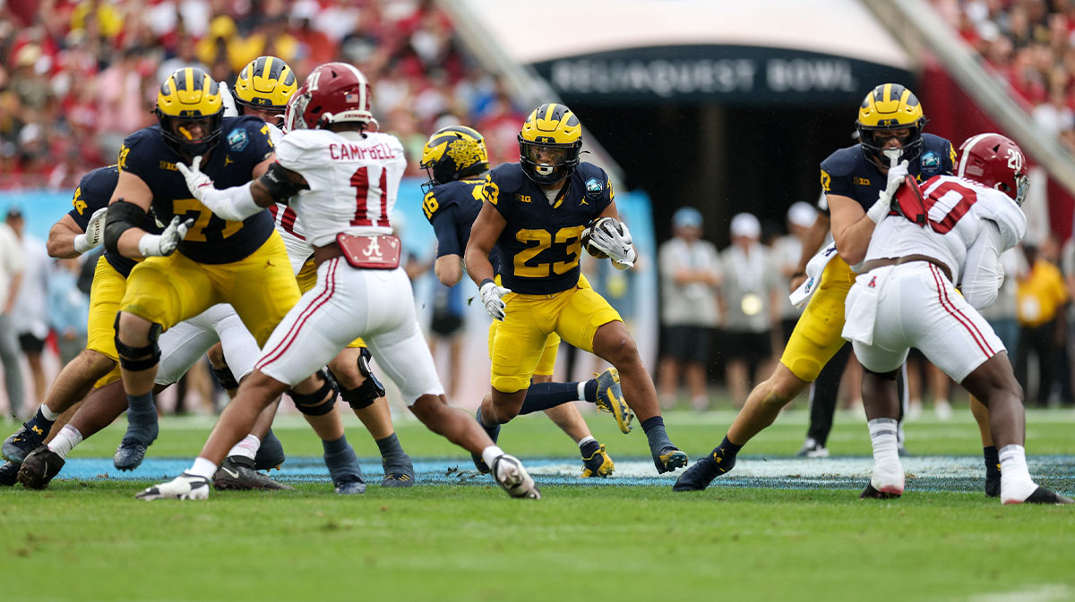 Michigan Wolverines running back Jordan Marshall (23) runs with the ball against the Alabama Crimson Tide in the first quarter during the ReliaQuest Bowl at Raymond James Stadium.