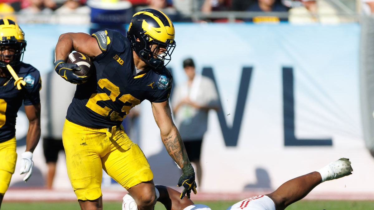 Michigan Wolverines running back Jordan Marshall (23) pushes off on Alabama Crimson Tide linebacker Jeremiah Alexander (35) during the second half at Raymond James Stadium.