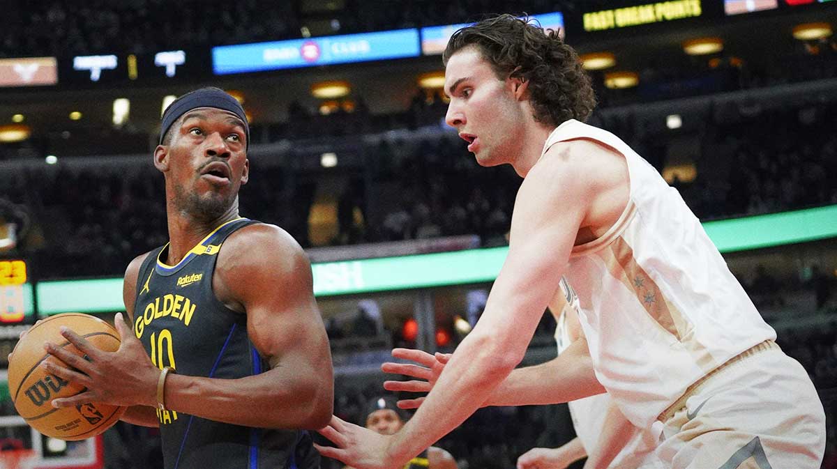 Chicago Bulls guard Josh Giddey (3) defends Golden State Warriors forward Jimmy Butler (10) during the first half at United Center.