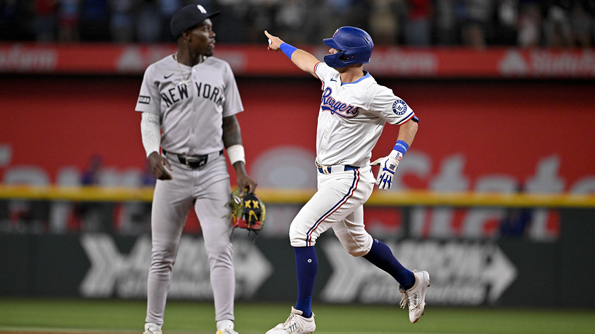 Texas Rangers designated hitter Josh Jung (6) rounds the bases past New York Yankees second baseman Jazz Chisholm Jr. (13) after Jung hits a game winning home run during the tenth inning at Globe Life Field.