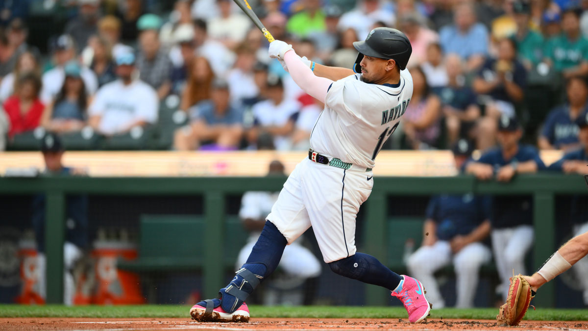 Seattle Mariners first baseman Josh Naylor (12) hits a single against the Chicago White Sox during the first inning at T-Mobile Park.