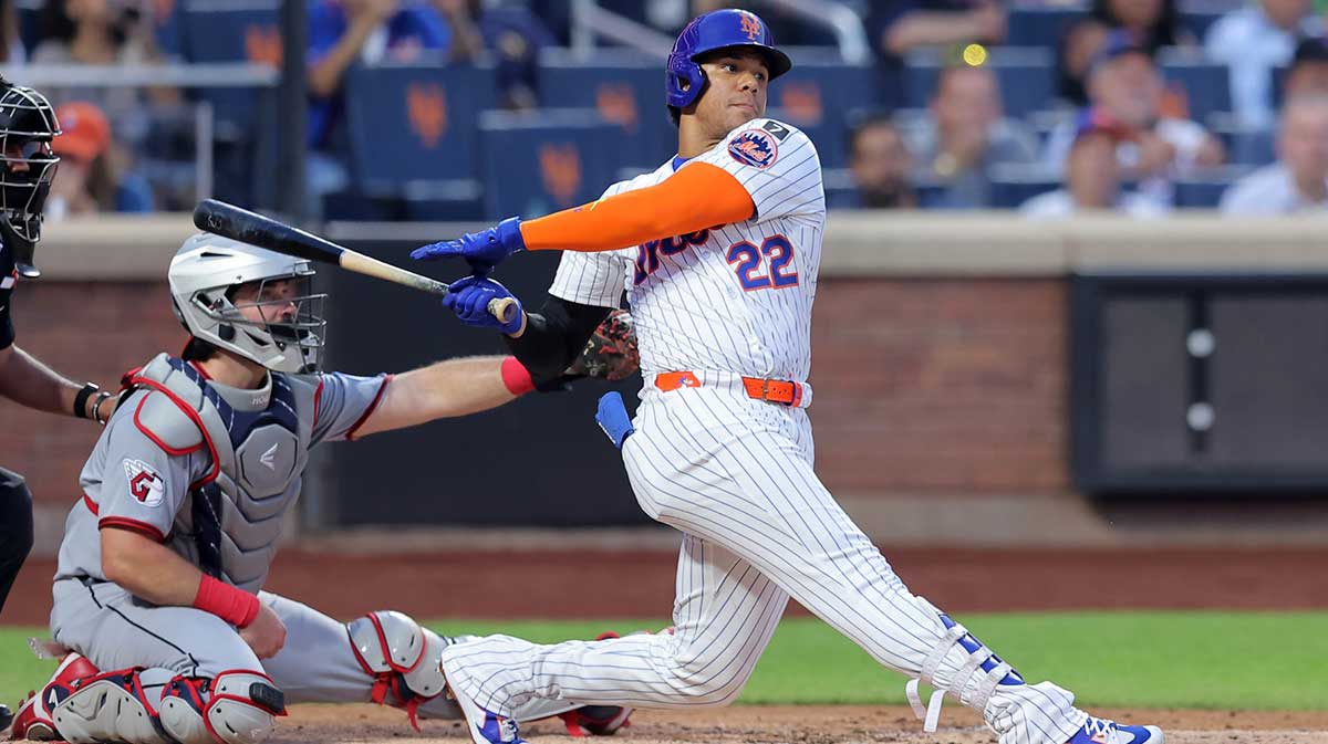 New York Mets right fielder Juan Soto (22) follows through on a single against the Cleveland Guardians during the fourth inning