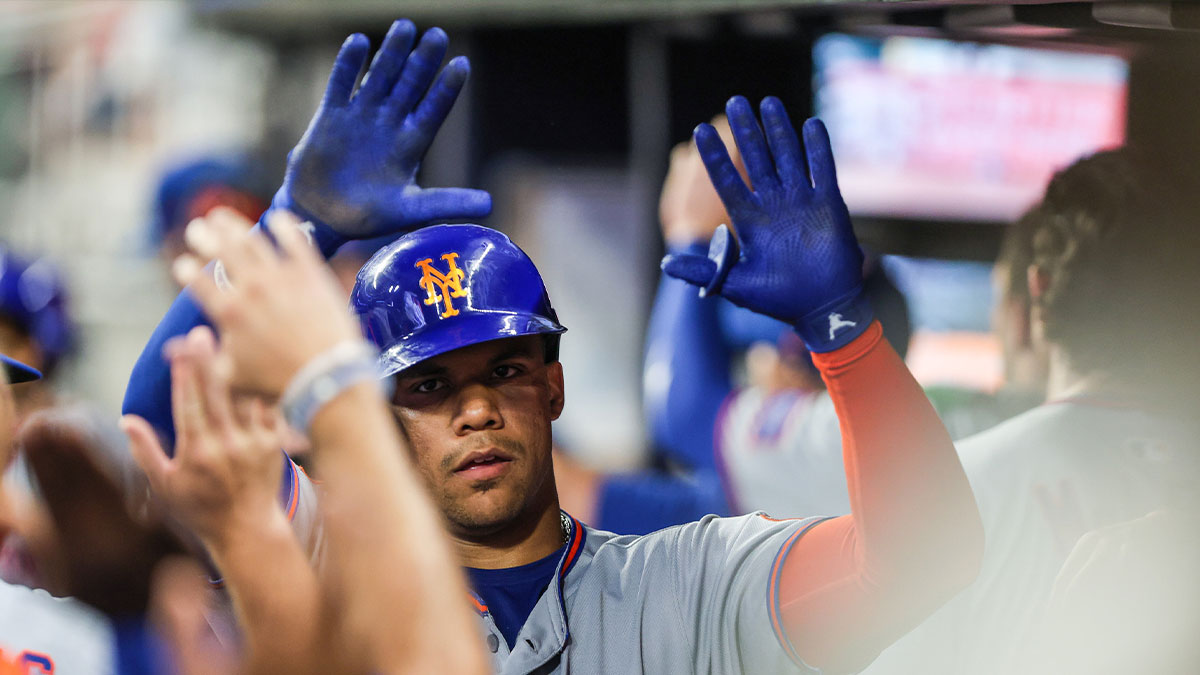 Aug 22, 2025; Cumberland, Georgia, USA; New York Mets outfielder Juan Soto (22) celebrates a home run hit against the Atlanta Braves in the dugout during the seventh inning at Truist Park.