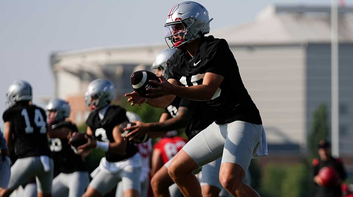 Ohio State Buckeyes quarterback Julian Sayin (10) takes a snap during football training camp at the Woody Hayes Athletic Center