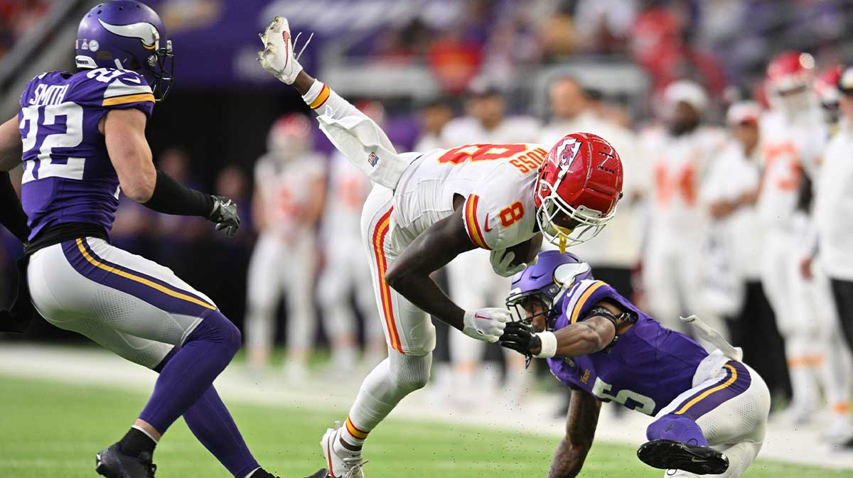 Kansas City Chiefs wide receiver Justyn Ross (8) gets yards after the catch as safety Harrison Smith (22) and cornerback Mekhi Blackmon (5) make the tackle during the third quarter at U.S. Bank Stadium.